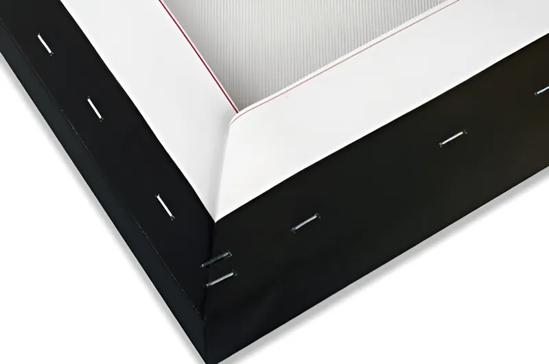 The back corner of a standard canvas: the canvas stapled over a wooden frame, the back open