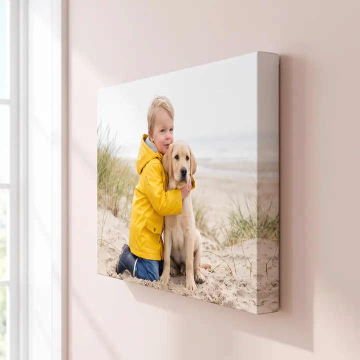 A pro canvas of a boy and a labrador on a beach, seen from the side so its deep edge stands off the wall