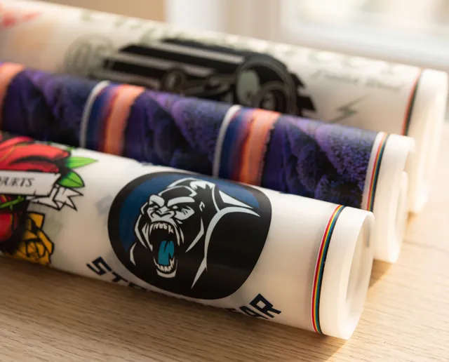 Rolls of DTF transfer film printed with full-colour designs