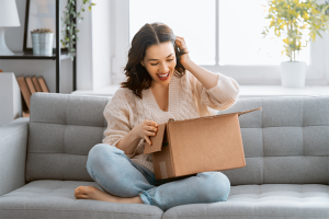 Smiling Woman Opening Package